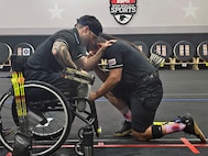 JP Lane offered support and prayer to teammate and Ultimate Champion athlete Justin Mathers before Mathers competed and won gold in an archery competition at the 2024 DOD Warrior Games