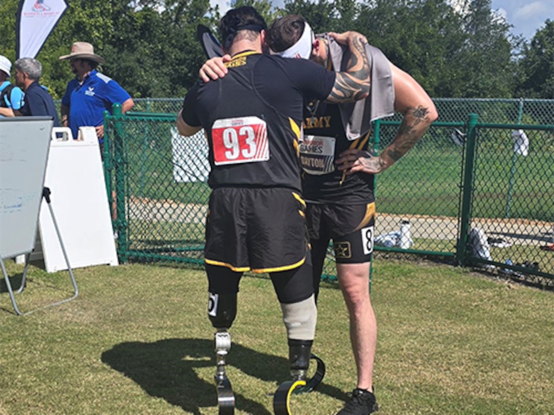 JP Lane and teammate Patrick Dayton were in a moment of prayer before Dayton’s 1500-meter race