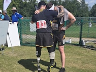 JP Lane and teammate Patrick Dayton were in a moment of prayer before Dayton’s 1500-meter race