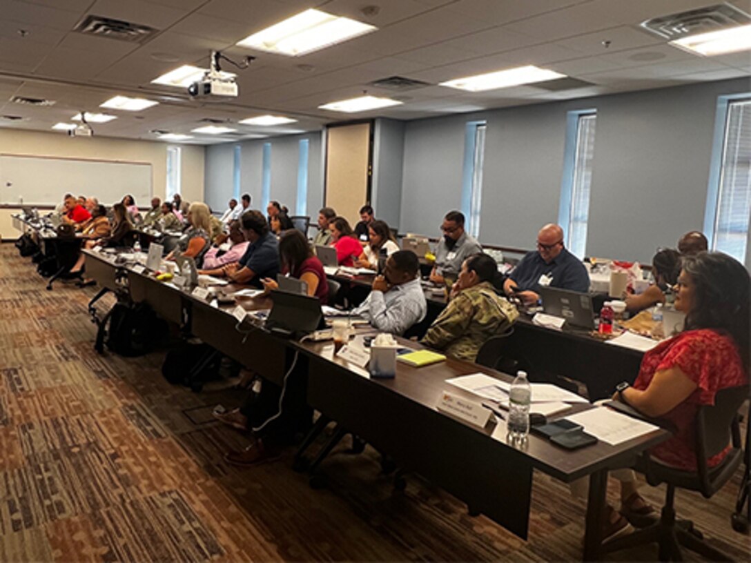 Mary Ball, far right, listens with Transition Coordinators to Sgt. Major Imari Jackson at the 2024 Transition Coordinator Sustainment Training