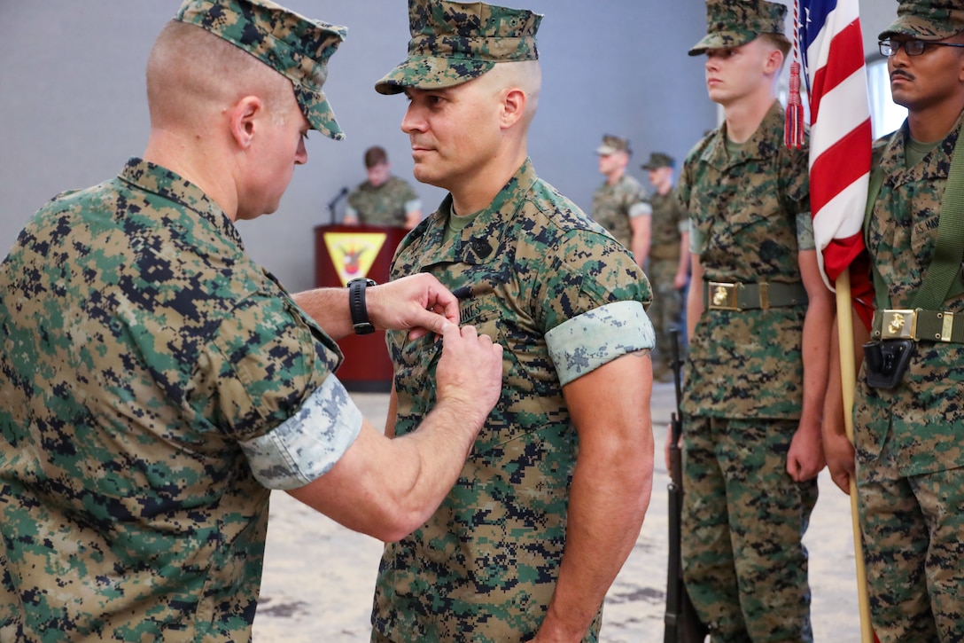 U.S. Marine Corps Lt. Col. Nicholas Vetra, left, from Pennsylvania and commanding officer of Marine Aviation Logistics Squadron 14, awards a Meritorious Service Medal to Sgt. Maj. Kevin Mason, from Oregon and former command senior enlisted leader of Marine Aviation Logistics Squadron 14, during a relief and appointment ceremony at Marine Corps Air Station Cherry Point, North Carolina, July 19, 2024. The ceremony represented a transfer of responsibility, authority, and accountability from Sgt. Mason to Sgt. Maj. Donald Swanner. (U.S. Marine Corps photo by Staff Sgt. Theodore Bergan)