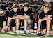 Local high school football players pause at a football clinic for a block of instruction.