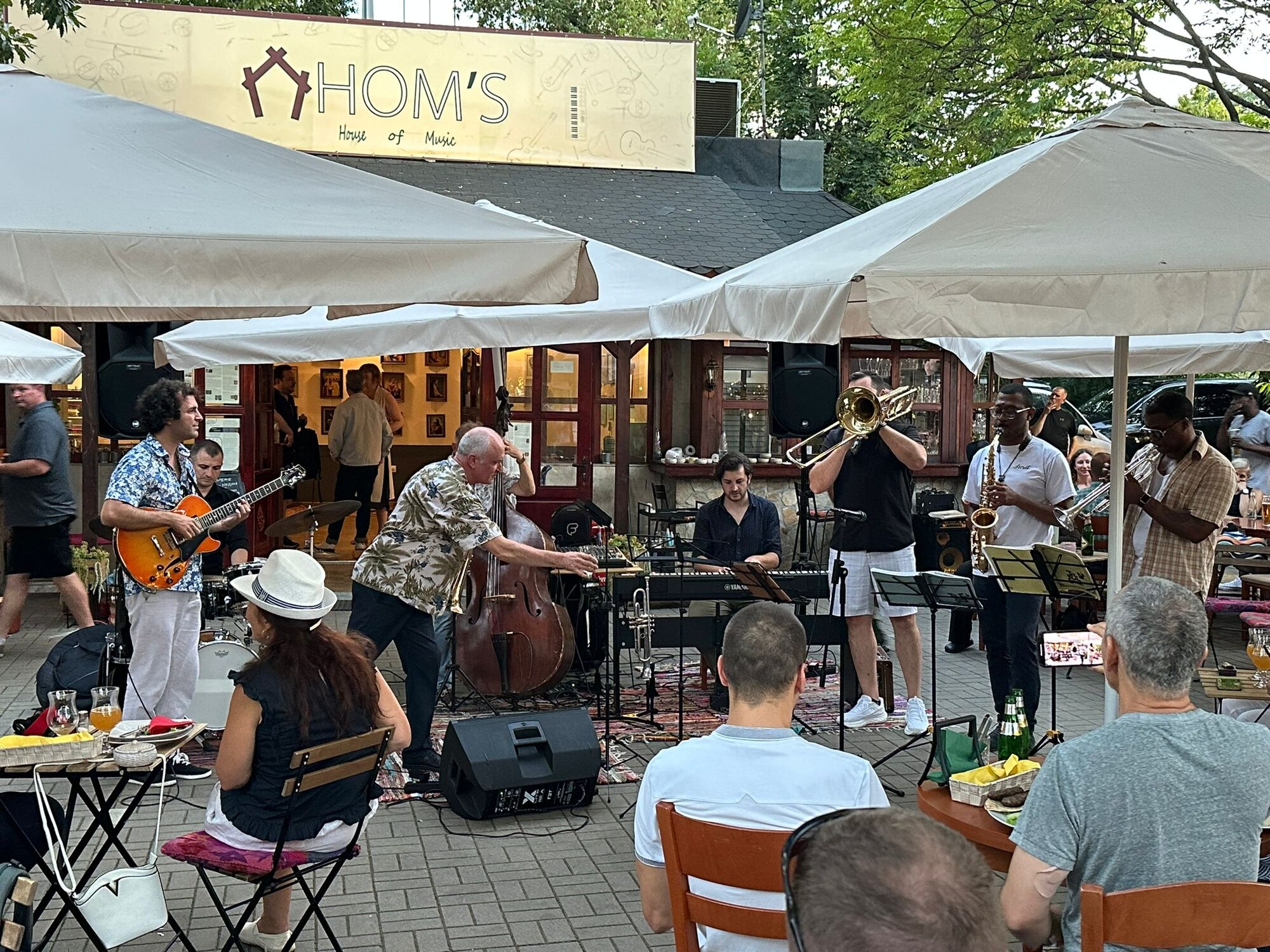 Army band members performing with Bulgarian musicians at a local restaurant.