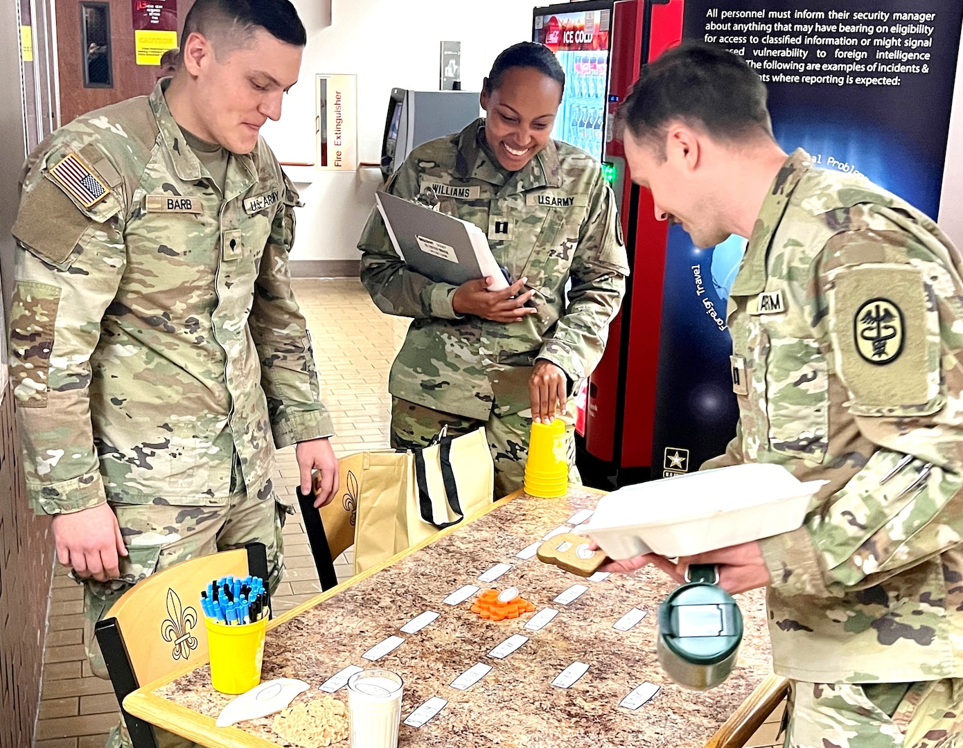 Three Soldiers looking at a display table