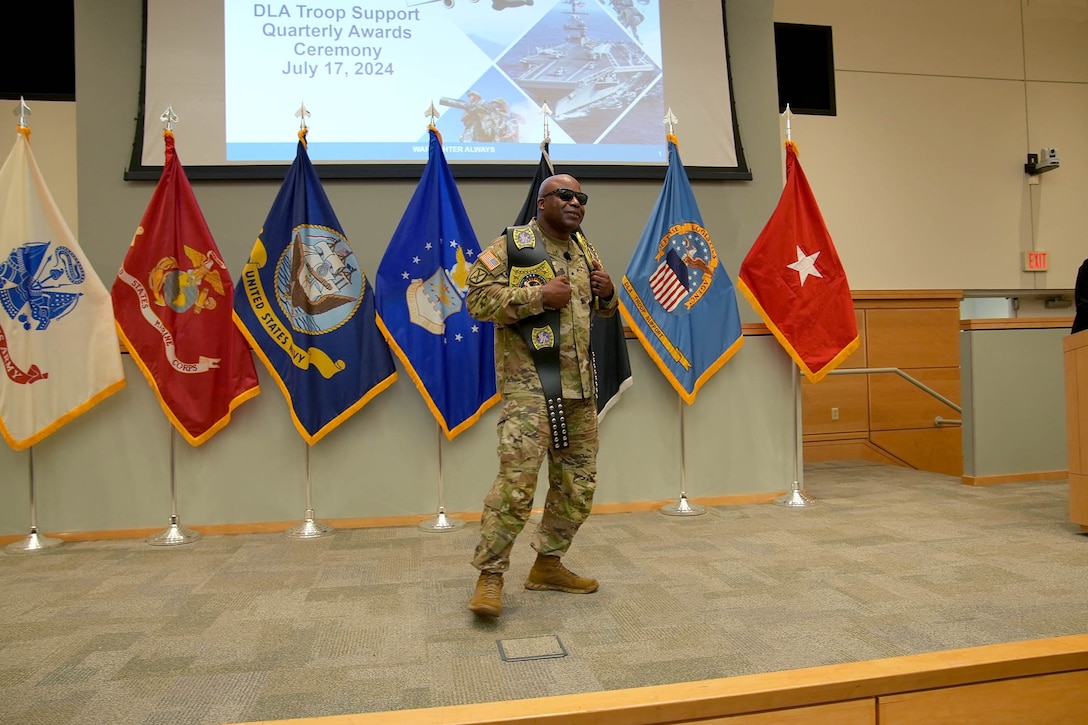 Defense Logistics Agency Troop Support Commander Army Brig. Gen. Landis Maddox hypes up the crowd while donning the Supervisor and Employee of the year "Championship" belts during the organization's awards ceremony July 17 in Philadelphia