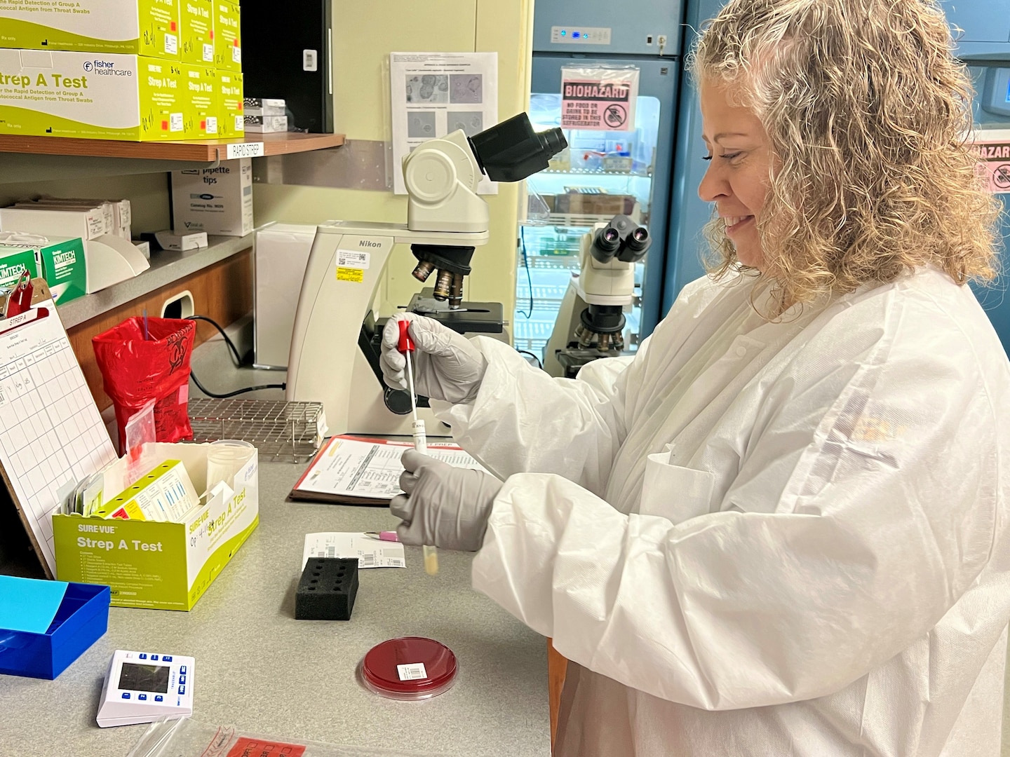 Laboratory Technician looking at the results of a strep test