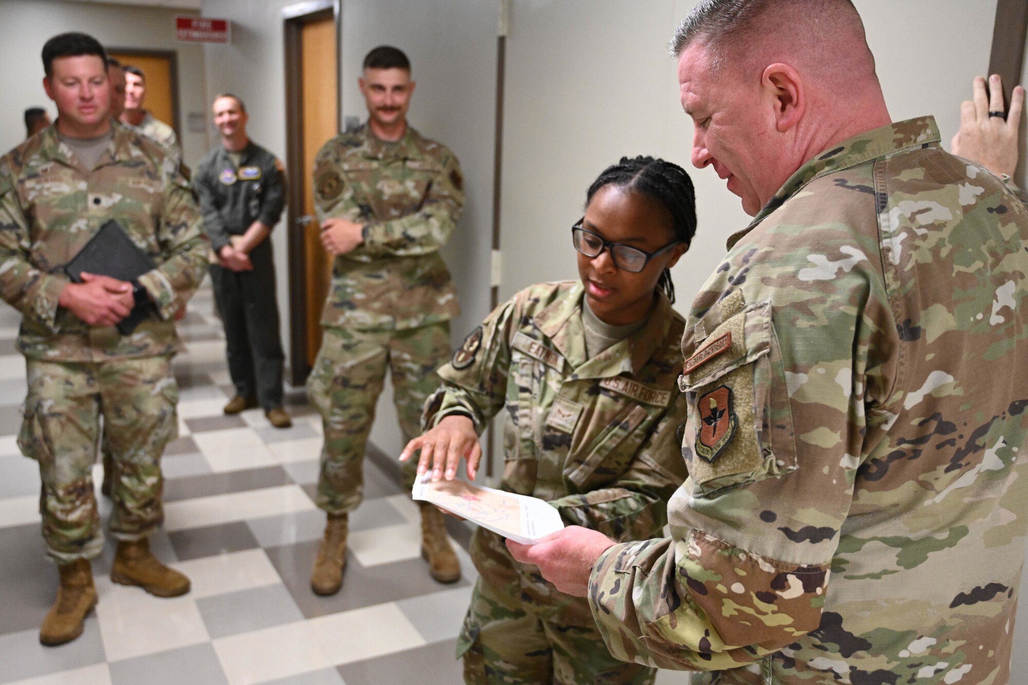 U.S. Air Force Airman 1st Class Deja Eatmon, 97th Healthcare Operations Squadron referral technician, shows a map of the local area to Chief Master Sgt. Chad Bickley, command chief of Air Education and Training Command, at Altus Air Force Base (AFB), Oklahoma, July 10, 2024. Eatmon explained the referral process at Altus AFB. (U.S. Air Force photo by Senior Airman Miyah Gray)