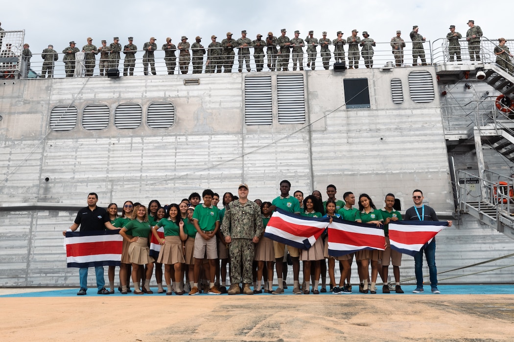 U.S. Navy Lt. Cmdr. Zachary Smith, mission commander for Continuing Promise 2024 poses for a group photo with local students, as Spearhead-class expeditionary fast transport ship USNS Burlington (T-EPF 10) makes preparations to depart Limón, Costa Rica, during Continuing Promise 2024.