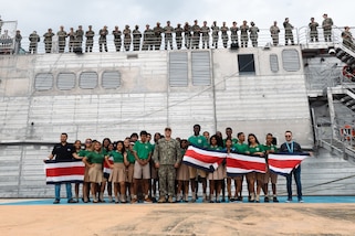 U.S. Navy Lt. Cmdr. Zachary Smith, mission commander for Continuing Promise 2024 poses for a group photo with local students, as Spearhead-class expeditionary fast transport ship USNS Burlington (T-EPF 10) makes preparations to depart Limón, Costa Rica, during Continuing Promise 2024.