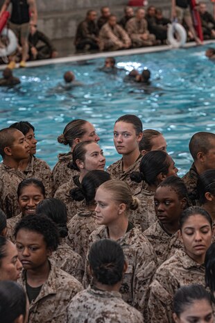U.S. Marine Corps recruits with Fox Company, 2nd Recruit Training Battalion, wait to jump off the 10-foot tower during the water survival training class at Marine Corps Recruit Depot San Diego, California, July 23, 2024. Recruits are taught basic water survival prior to conducting their basic swim qualification. Basic swim qualification consists of a 25-meter swim, a 10-foot tower jump into the water, four-minute tread, 25-meter pack swim and an underwater gear shed. (U.S. Marine Corps photo by Lance Cpl. Alexandra M. Earl)