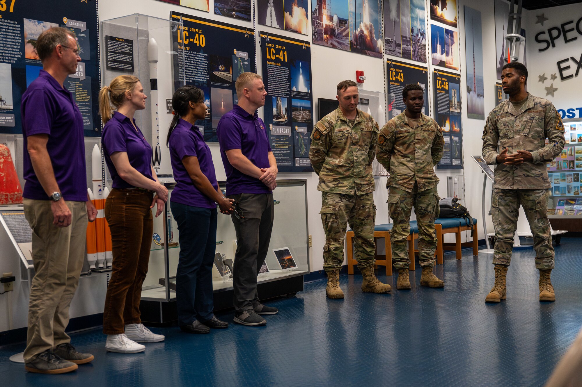 Service members address the Crew-9 crew members.
