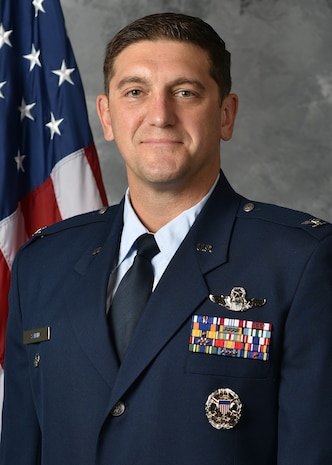 a man posing for an official photo.