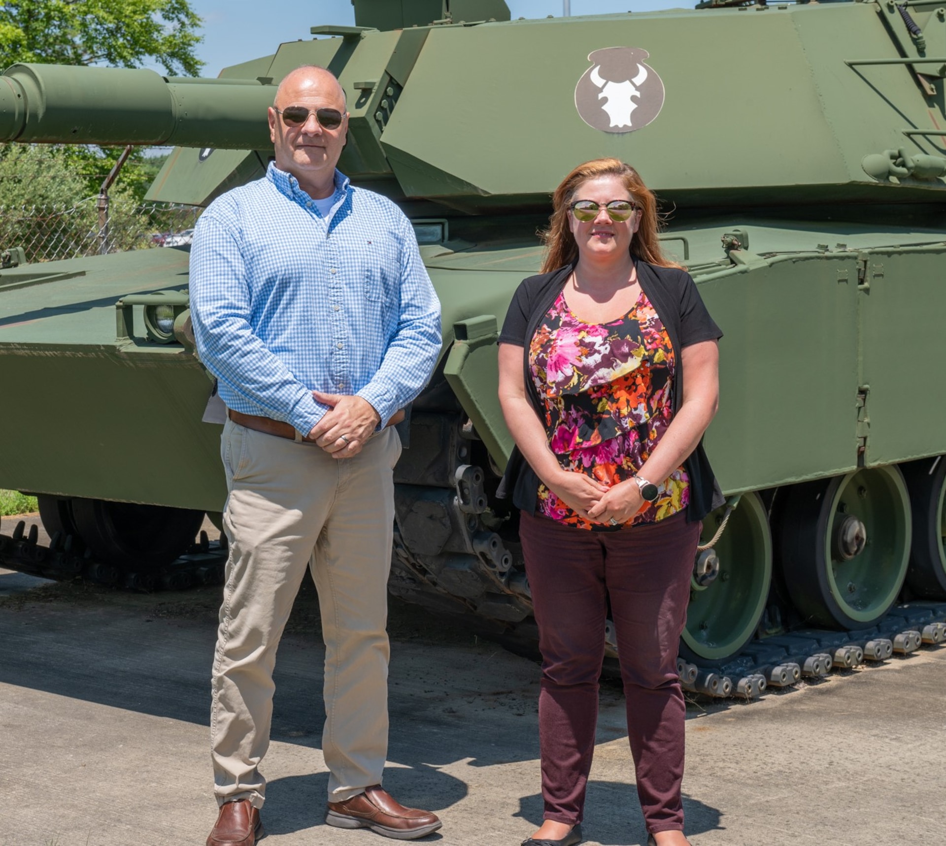 Photo of Paul DePrimo and Jennifer Caldero standing in front of a tank