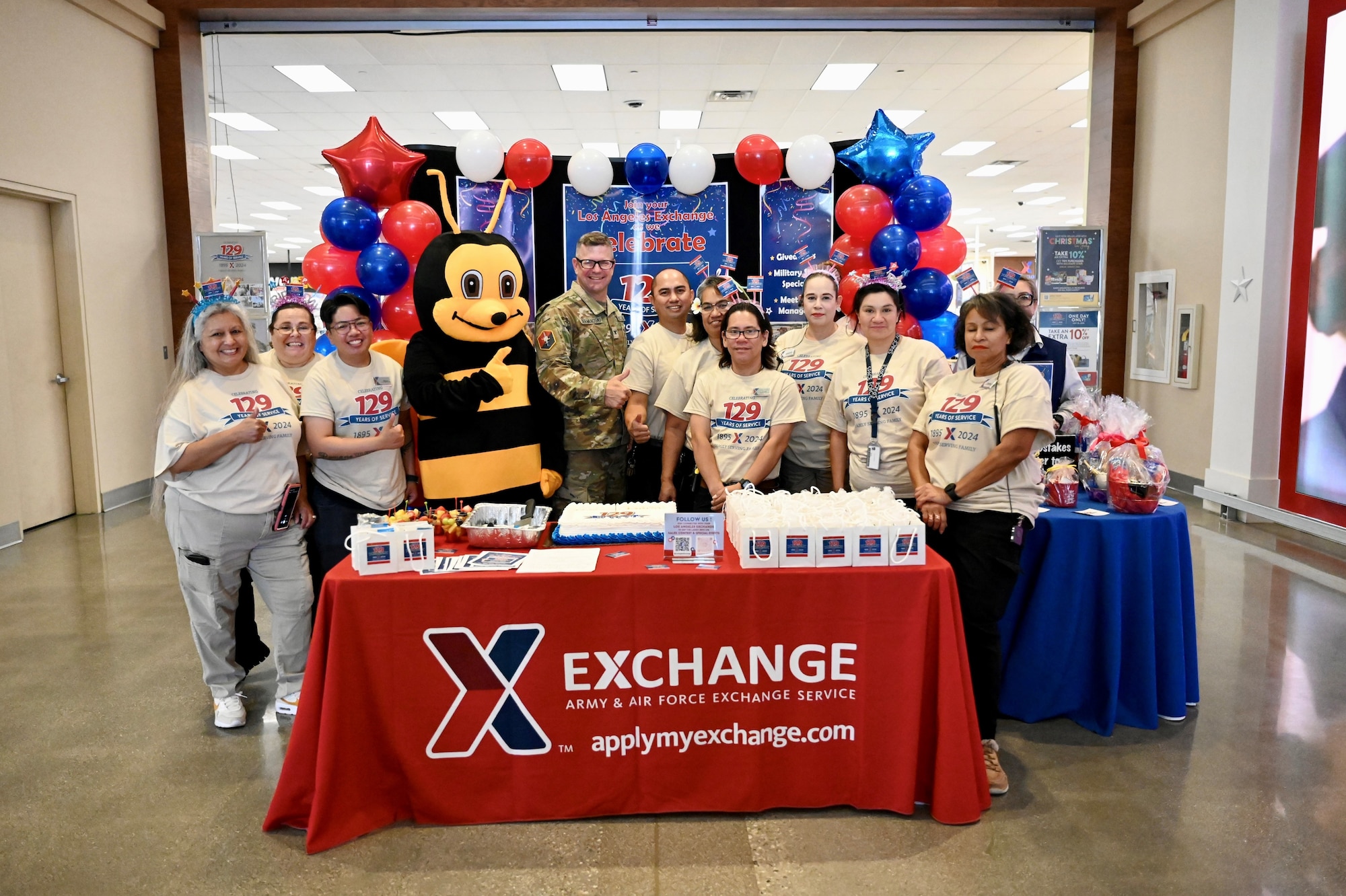 Members of the Exchange host a cake cutting ceremony and present a check to the Commander of Los Angeles Air Force Base during their 129th anniversary celebration.