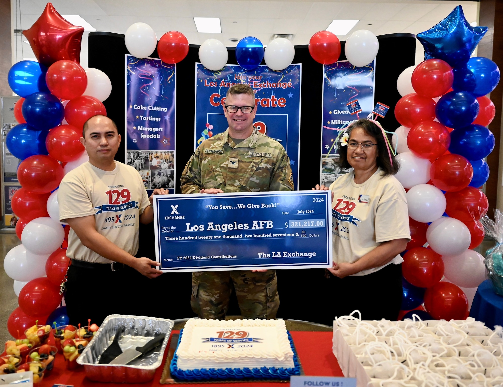 Members of the Exchange host a cake cutting ceremony and present a check to the Commander of Los Angeles Air Force Base during their 129th anniversary celebration.