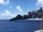 The Coast Guard Cutter Bernard C. Webber arriving on the scene of a burning 42-foot cabin cruiser near Dania Beach, Florida, July 25, 2024. Coast Guard and Broward Fire Rescue boat crews rescued two people with no medical concerns before extinguishing the flames.