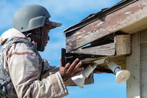 An Airman works on a building