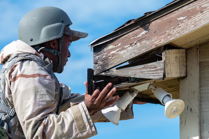 An Airman works on a building
