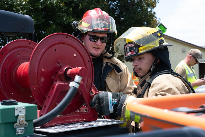 Firefighters put away equipment