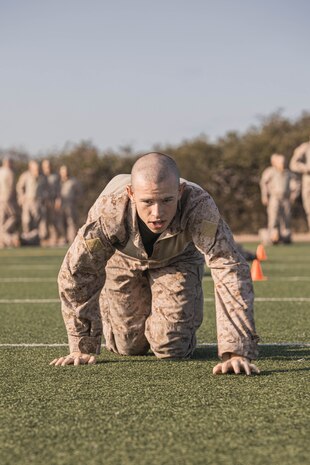 A U.S. Marine Corps recruit with Bravo Company, 1st Recruit Training Battalion, executes conditioning drills as part of the introduction to the combat fitness test at Marine Corps Recruit Depot San Diego, California, July 24, 2024. The recruits were introduced to the CFT by conducting portions of the test individually. The CFT is an annual fitness test that is required of all Marines to pass and maintain consisting of an 880-yard sprint, ammunition can lifts, and a maneuver under fire drill. (U.S. Marine Corps photo by Lance Cpl. Alexandra M. Earl)