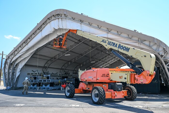 Airmen from the 635th Materiel Maintenance Squadron, based at Holloman Air Force Base, New Mexico, complete repairs on a clamshell tension fabric shelter system for 309th Aircraft Maintenance Group at Hill Air Force Base, Utah. The shelter stores critical aircraft parts and is used for “pack-and-crate” operations, where aircraft are prepared for ground or air transportation. (U.S. Air Force photo by Cynthia Griggs)