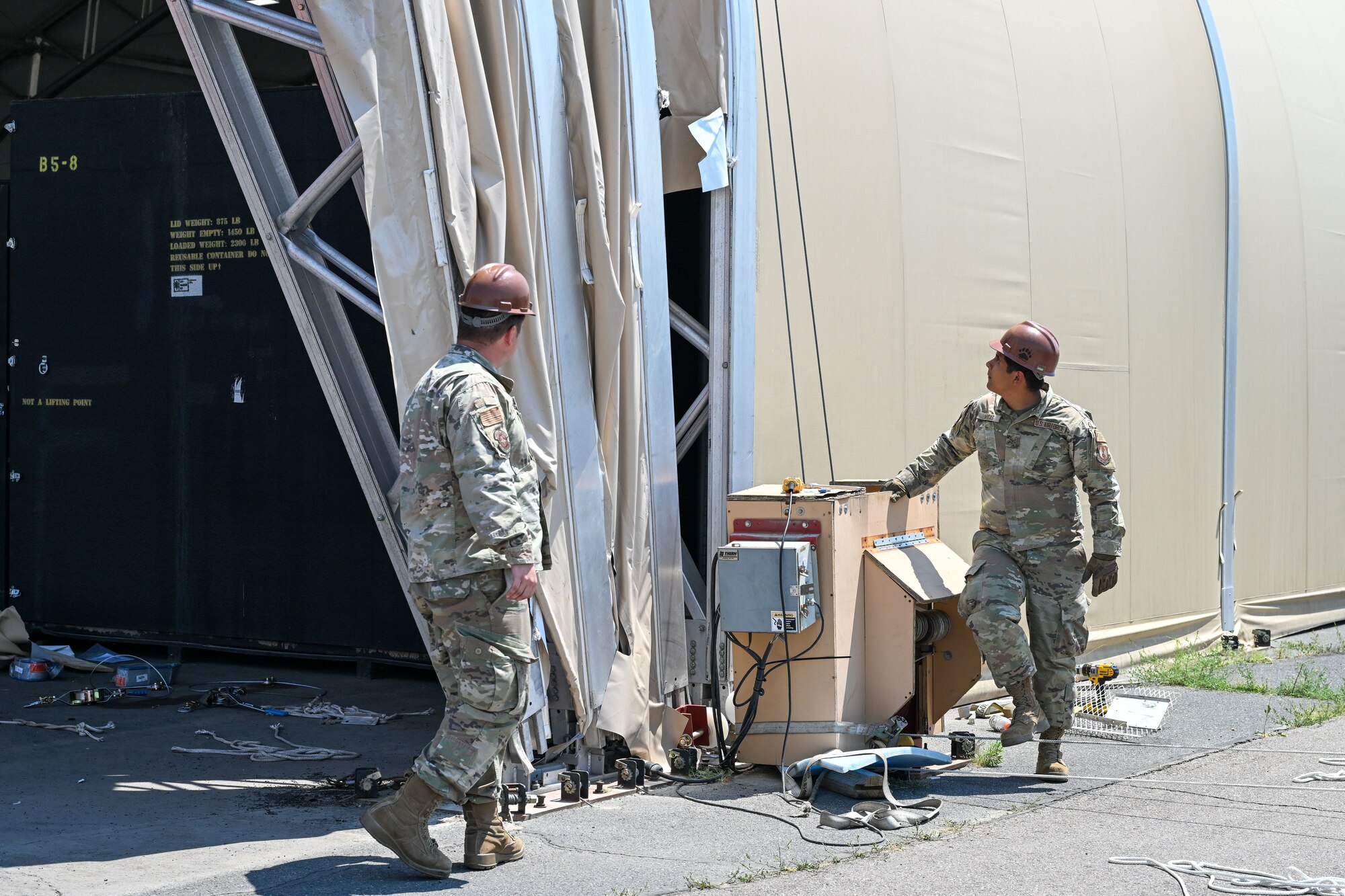 Airmen from the 635th Materiel Maintenance Squadron, based at Holloman Air Force Base, New Mexico, complete repairs on a clamshell tension fabric shelter system for 309th Aircraft Maintenance Group at Hill Air Force Base, Utah. The shelter stores critical aircraft parts and is used for “pack-and-crate” operations, where aircraft are prepared for ground or air transportation. (U.S. Air Force photo by Cynthia Griggs)