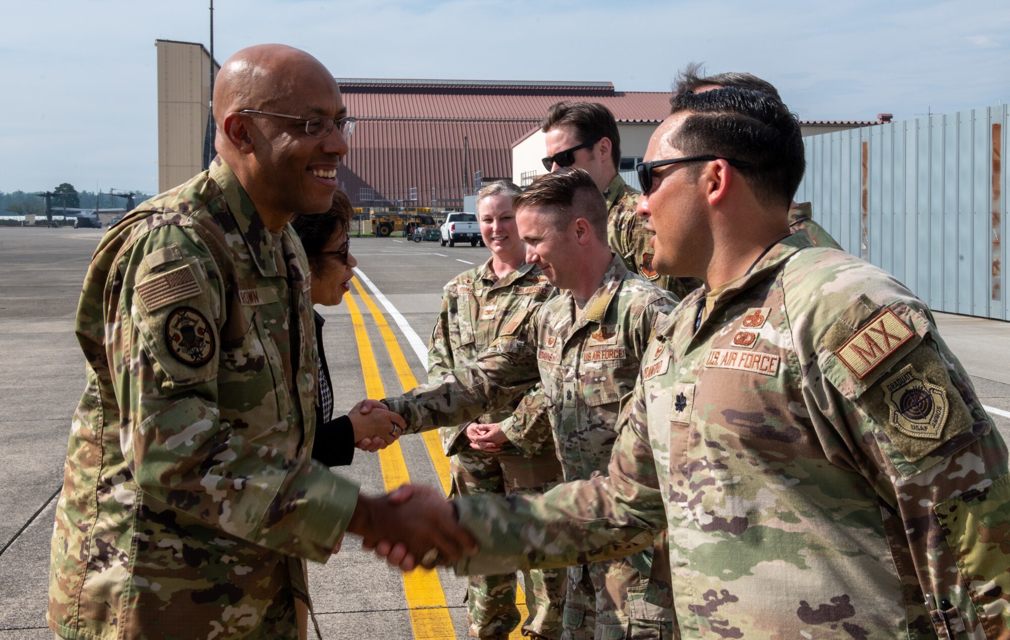 U.S. Air Force Gen. Charles Q. Brown Jr., Chairman of the U.S. Joint Chiefs of Staff, and his spouse Sharene Brown, greet 353rd Special Operations Wing, 21st Special Operations Squadron and 21st Special Operations Aircraft Maintenance Squadron leadership on the flight line at Yokota Air Base, Japan,