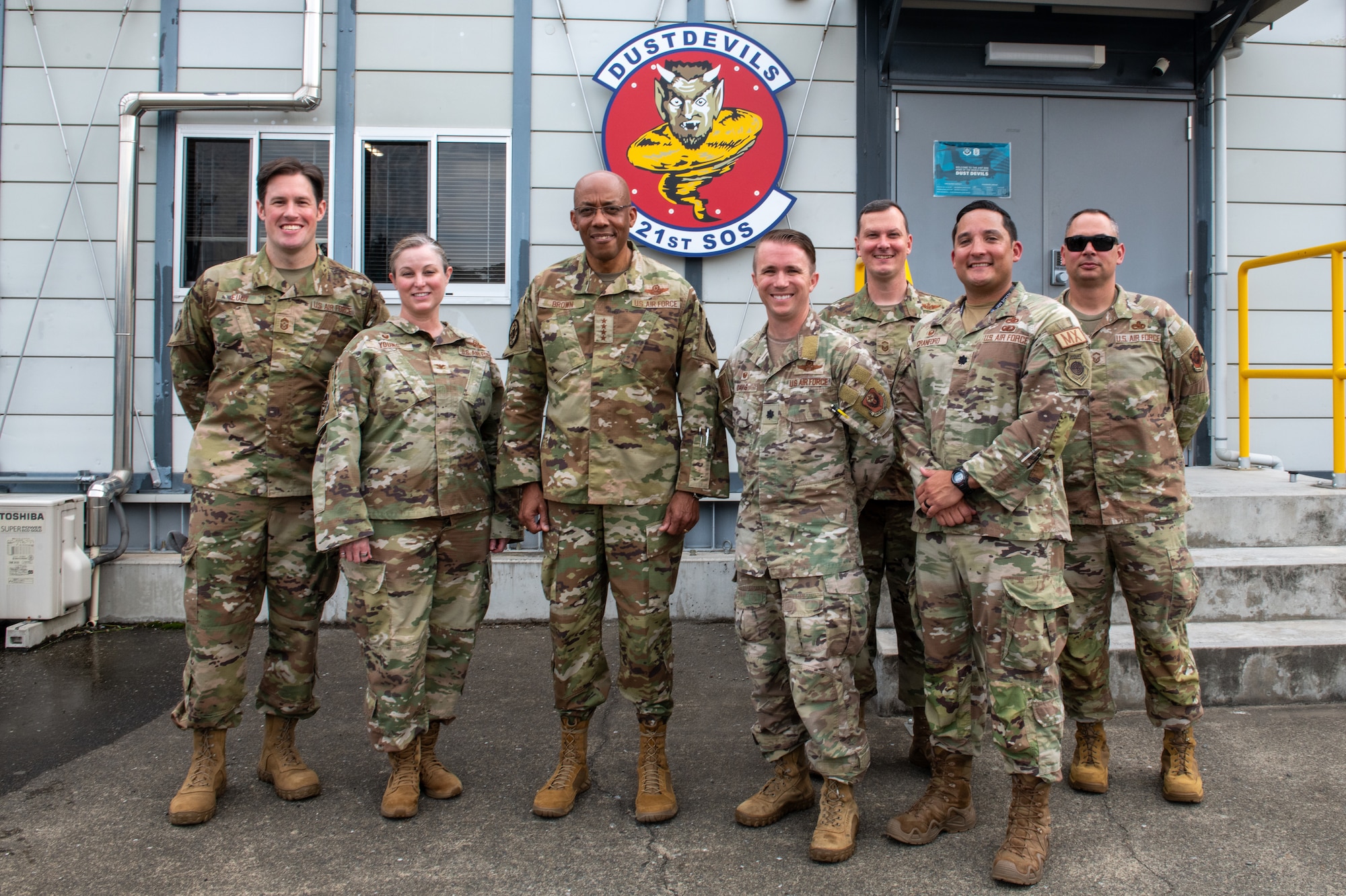 U.S. Air Force members pose outside of the 21st Operations Squadron building with the Chairman of the Joint Chiefs of Staff