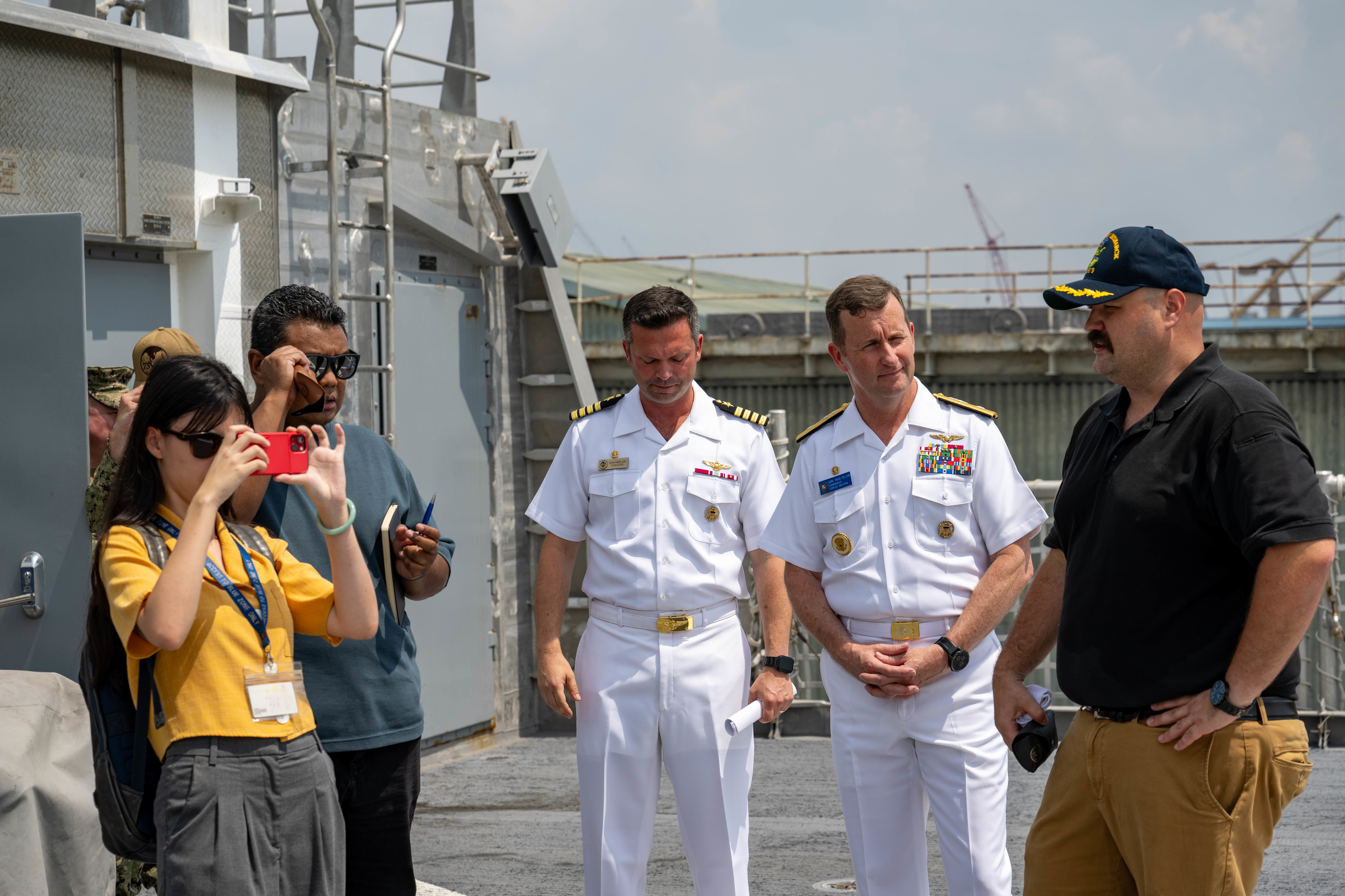 SINGAPORE (July 23, 2024) Civil service mariner Capt. Christopher Jackson, captain of the Spearhead-class expeditionary fast transport ship USNS City of Bismarck (T-EPF 9), right, gives a tour to Rear Adm. Mark A. Melson, Commander, Logistics Group Western Pacific/Task Force 73 (COMLOG WESTPAC/CTF 73) and U.S. Pacific Fleet Executive Agent for Pacific Partnership, and local reporters, during a scheduled port visit to Singapore Naval Installation (SNI) as part of Pacific Partnership. Now in its 20th iteration, Pacific Partnership series is the largest annual multinational humanitarian assistance and disaster relief preparedness mission conducted in the Indo-Pacific. (U.S. Navy photo by Mass Communication Specialist 1st Class Jomark A. Almazan)