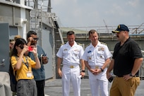 SINGAPORE (July 23, 2024) Civil service mariner Capt. Aaron Reiss, captain of the Spearhead-class expeditionary fast transport ship USNS City of Bismarck (T-EPF 9), right, gives a tour to Rear Adm. Mark A. Melson, Commander, Logistics Group Western Pacific/Task Force 73 (COMLOG WESTPAC/CTF 73) and U.S. Pacific Fleet Executive Agent for Pacific Partnership, and local reporters, during a scheduled port visit to Singapore Naval Installation (SNI) as part of Pacific Partnership. Now in its 20th iteration, Pacific Partnership series is the largest annual multinational humanitarian assistance and disaster relief preparedness mission conducted in the Indo-Pacific. (U.S. Navy photo by Mass Communication Specialist 1st Class Jomark A. Almazan)