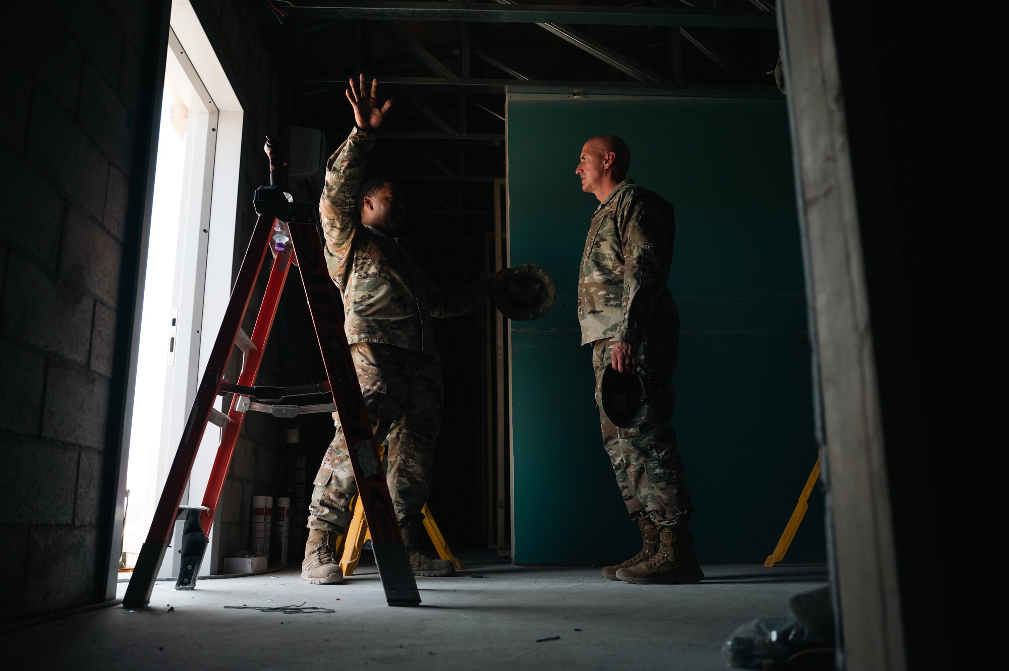 An Airman from the 386th Expeditionary Civil
Engineer Squadron briefs Chief Master Sgt.
of the Air Force David Flosi regarding new
yellowstone bathroom buildings.