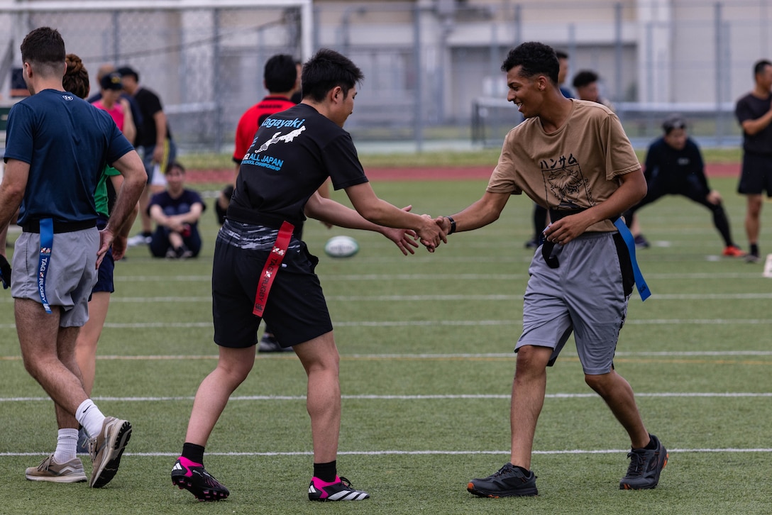 U.S. Marine Corps Pfc. Malikai Myers, right, a postal clerk with Headquarters and Headquarters Squadron, Marine Corps Air Station Iwakuni, and a native of Alabama, shakes hands with a member from Japan Maritime Self-Defense Force after a rugby match between rugby match between Marines and members of the Japan Self-Defense Force at MCAS Iwakuni, Japan, June 25, 2024. The rugby match was held as a way to bring Marines and JSDF members from MCAS Iwakuni together to build camaraderie through friendly competition. (U.S. Marine Corps photo by Lance Cpl. Dahkareo Pritchett)