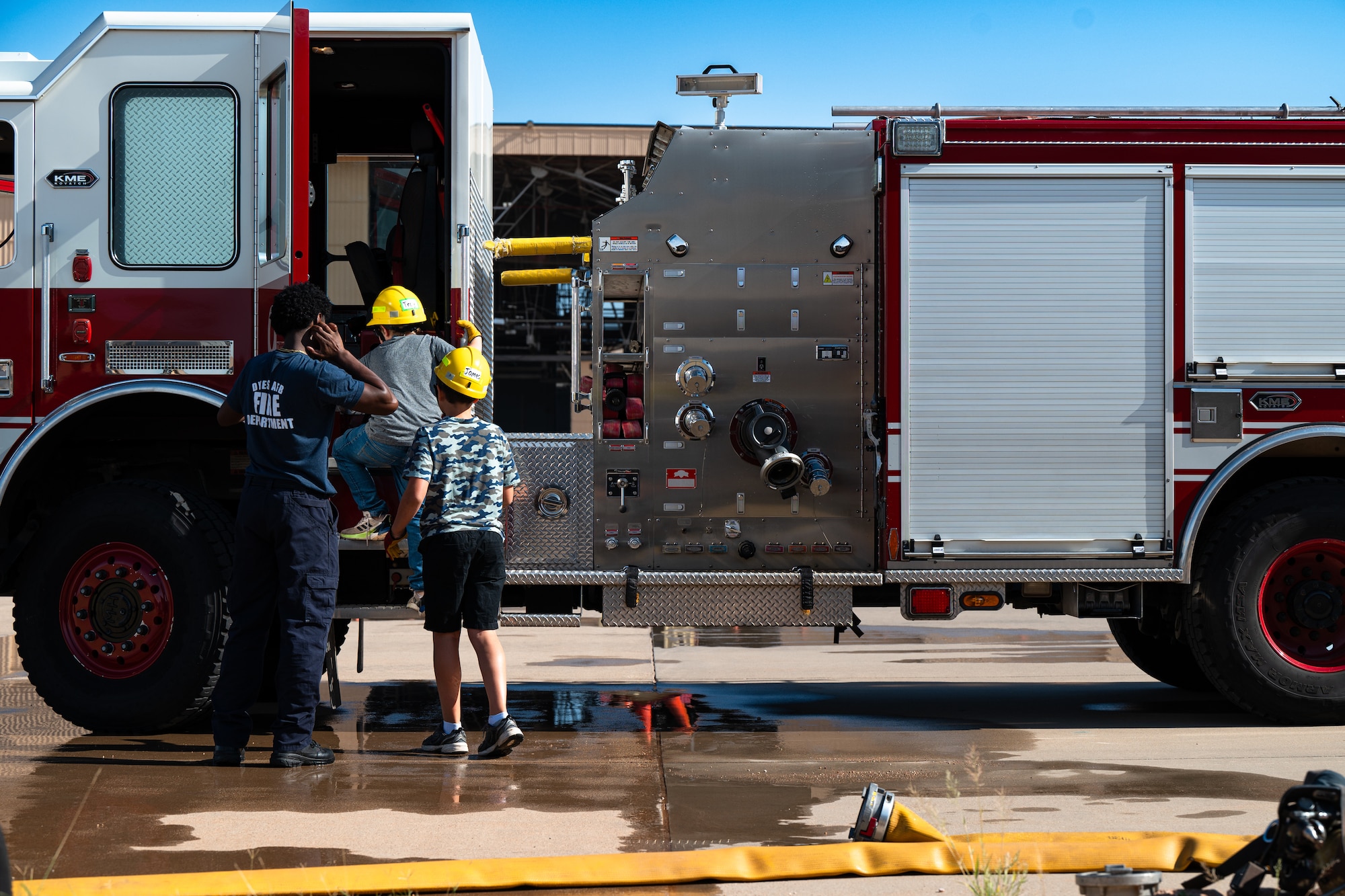Children enter a fire truck during Junior Firefighter Camp at Dyess Air Force Base, Texas, July 18, 2024. Dyess firefighters organized a drill for camp participants that included a ride in fire
truck as they responded to a simulated event. (U.S. Air Force photo by Airman 1st Class Jade M. Caldwell)