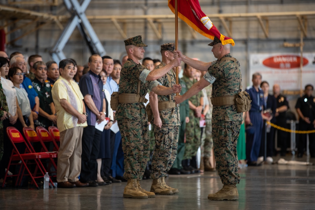 U.S. Marine Corps Sgt. Maj. Anthony J. Easton, right, sergeant major of Marine Corps Installations Pacific, passes the guidon to Maj. Gen. Stephen E. Liszewski, the outgoing commanding general of MCIPAC, during a change of command ceremony on Marine Corps Air Station Futenma, Okinawa, Japan, June 14, 2024. Liszewski served for two years as the commanding general and was relieved by Maj. Gen. Brian N. Wolford, who previously served as the director for plans policy strategy, United Nations Command, Combined Forces Command, United States Forces Korea. Liszewski and Wolford are natives of Maryland and Easton is a native of Minnesota. (U.S. Marine Corps photo by Sgt. Maximiliano Rosas)