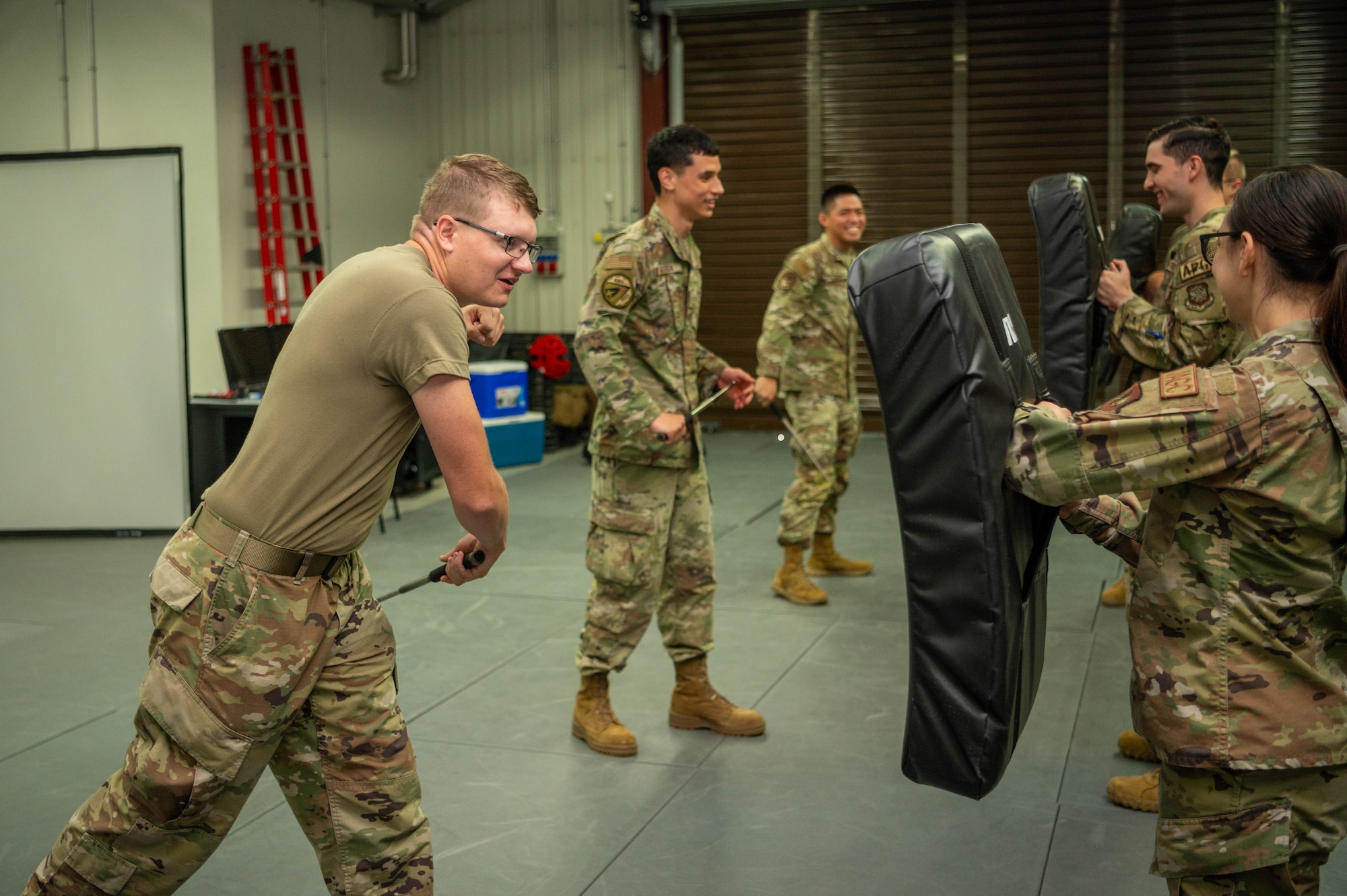 Service members use a tactical baton.