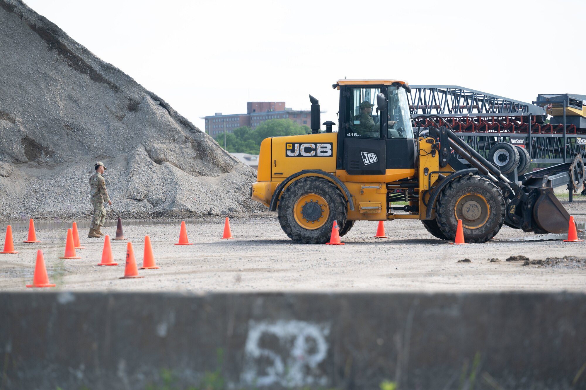 Airman drives heavy machinery during exercise to train how to use them