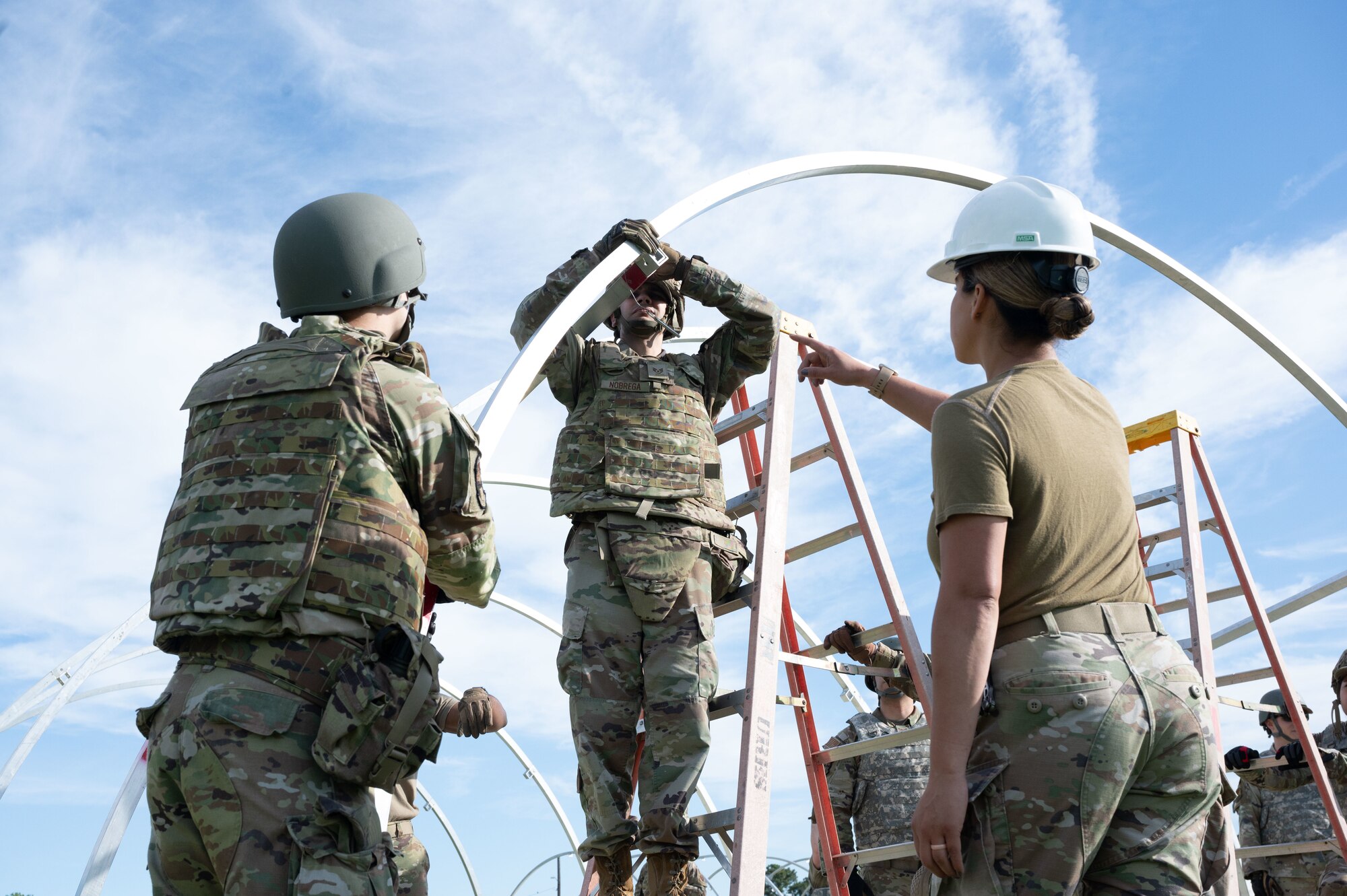 Airmen putting up a tent during exercise