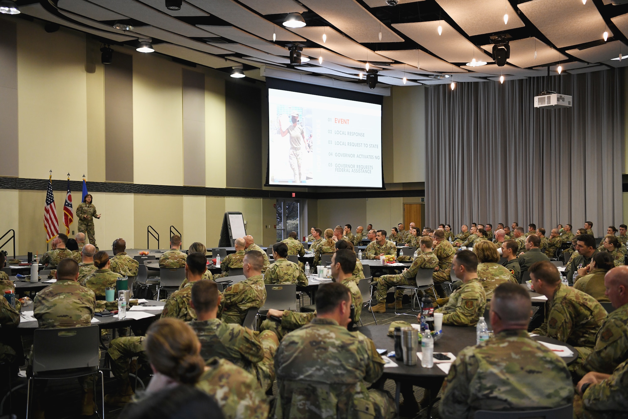 More than 100 airmen from across the country listen to a presenter speak during the Contemporary Base Issues course May 17, 2024 at the Hollenbeck Bayley Creative Arts and Conference Center in downtown Springfield, Ohio. The two-day training event, hosted by the 178th Wing, was designed to prepare Air National Guard officers, non-commissioned officers and other leaders to work together as a team. (U.S. Air National Guard photo by Shane Hughes)