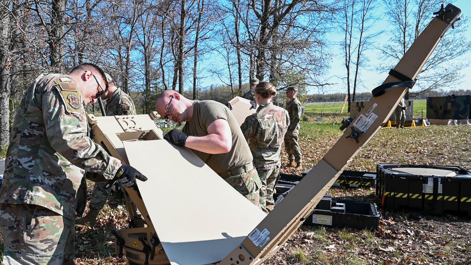 U.S. Air Force radio frequency transmissions systems specialists assigned to the 269th Combat Communications Squadron fasten panels to an Airbus Ranger 2400 flyaway terminal during annual training at Alpena Combat Readiness Training Center, Michigan, May 14, 2024. Rapid deployment and reliable communications are a key part of maintaining a strategic advantage in the era of great power competition. (U.S. Air National Guard photo by Staff Sgt. Constantine Bambakidis)