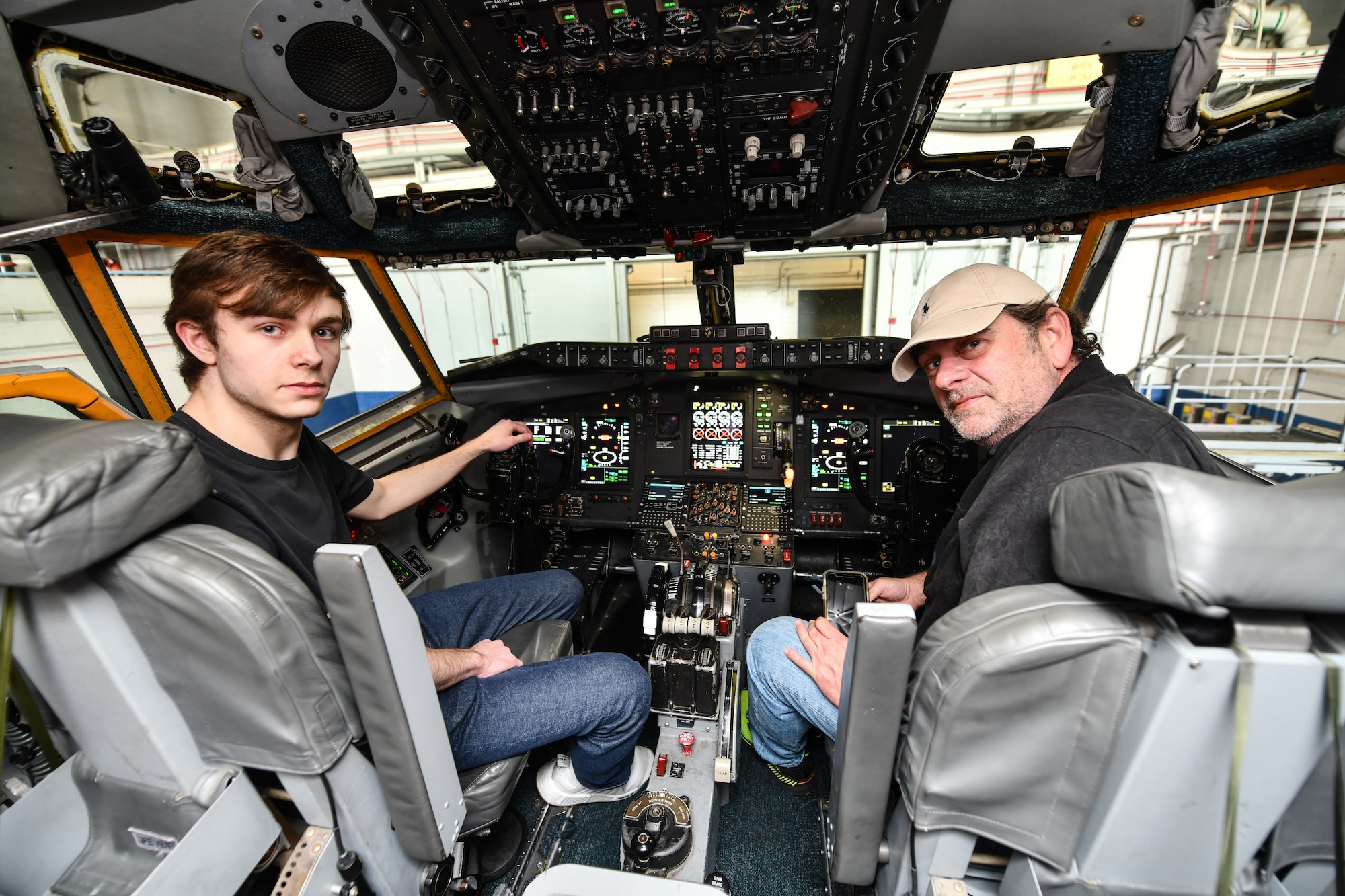Father and son sit in cockpit