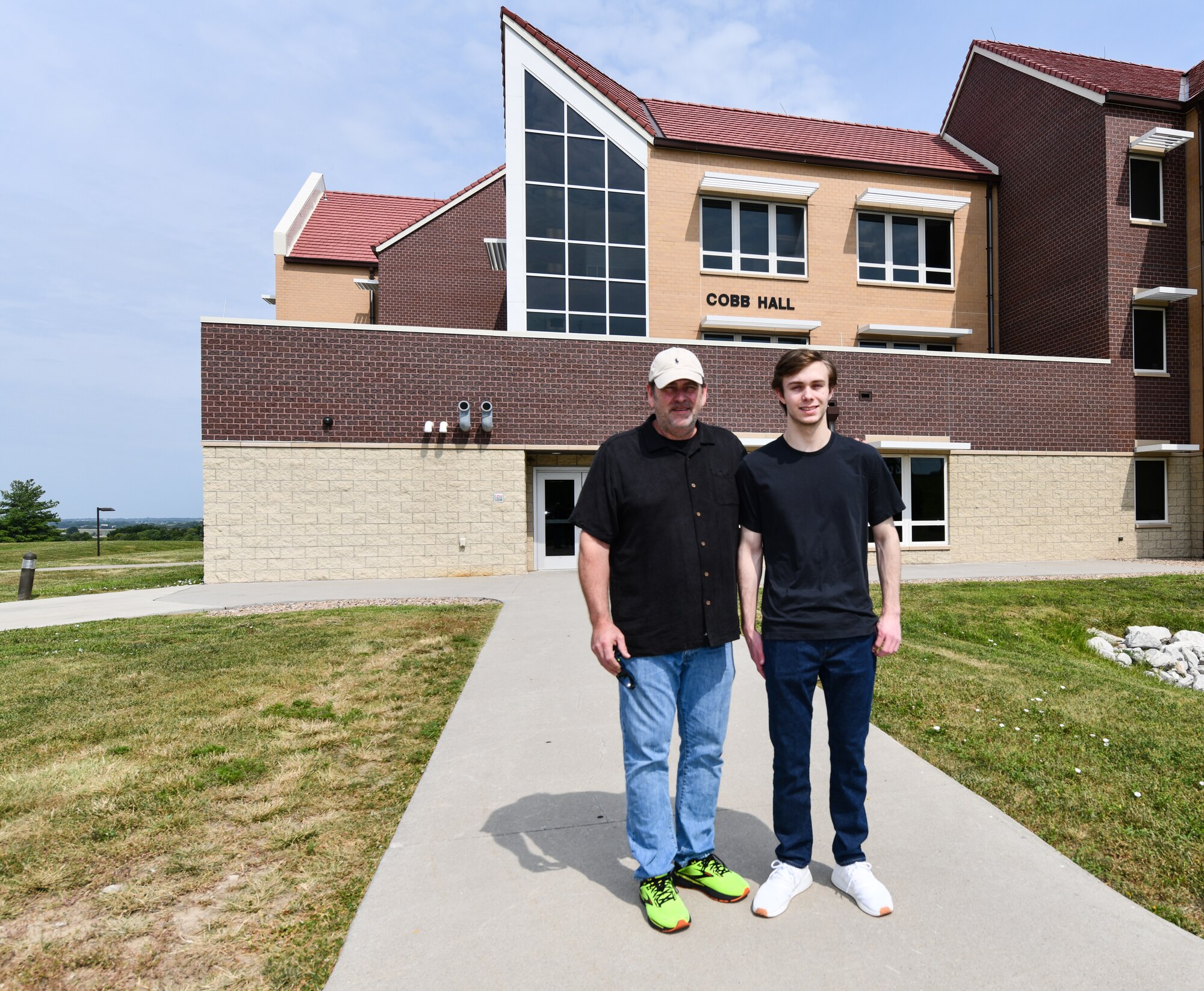 Father and son in front of dormitory