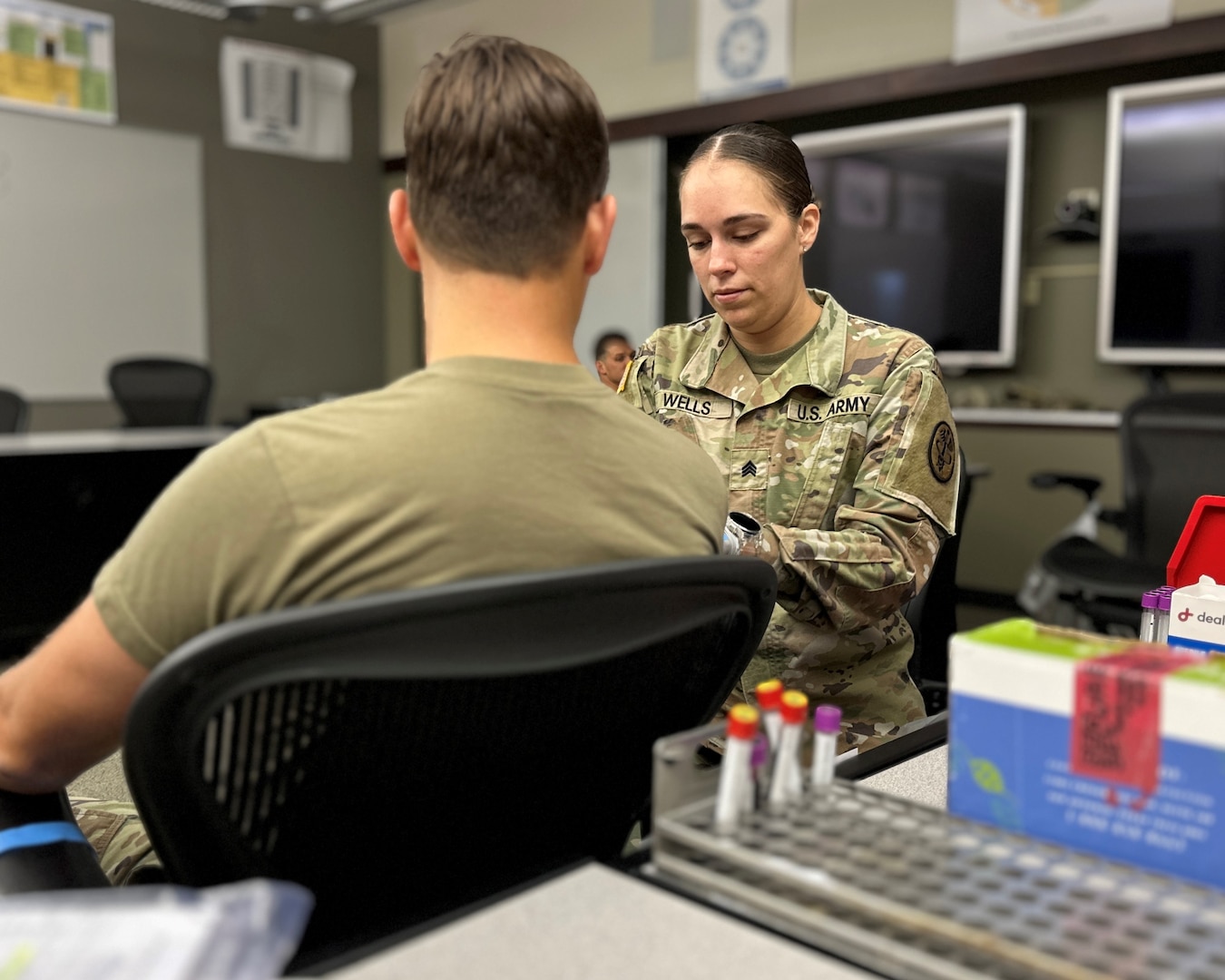 Female Soldier from a medical MOS caring for a patient.