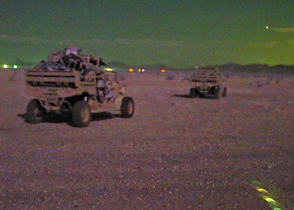 U.S. Air Force Special Warfare Team-3 members assigned to the 48th Rescue Squadron take off in utility task vehicles during a training scenario conducted by the 48th Rescue Squadron at the Barry M. Goldwater Range, Gila Bend, Ariz., July 18, 2024. The SWT-3 members were evaluated on their ability to rescue and recover personnel in a simulated mass casualty scenario. (U.S. Air Force photo by Staff Sgt. Abbey Rieves)