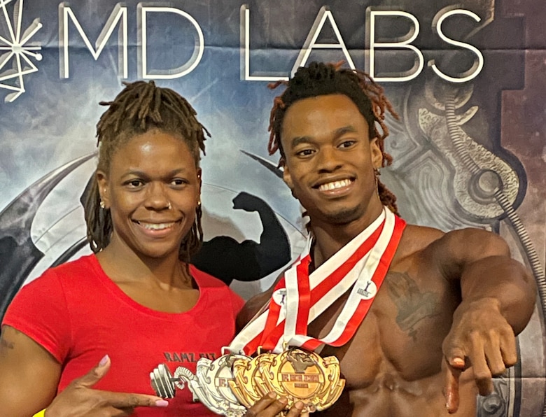 Glenda Canty, a contracting officer for the U.S. Army Corps of Engineers, Savannah District, stands with her son Chris Ramsey after the Dexter Classic NPC Bodybuilding Competition in Jacksonville, Florida, in July 2022. Canty participates in bodybuilding to demonstrate discipline and health to her children, who have also been influenced by her example.