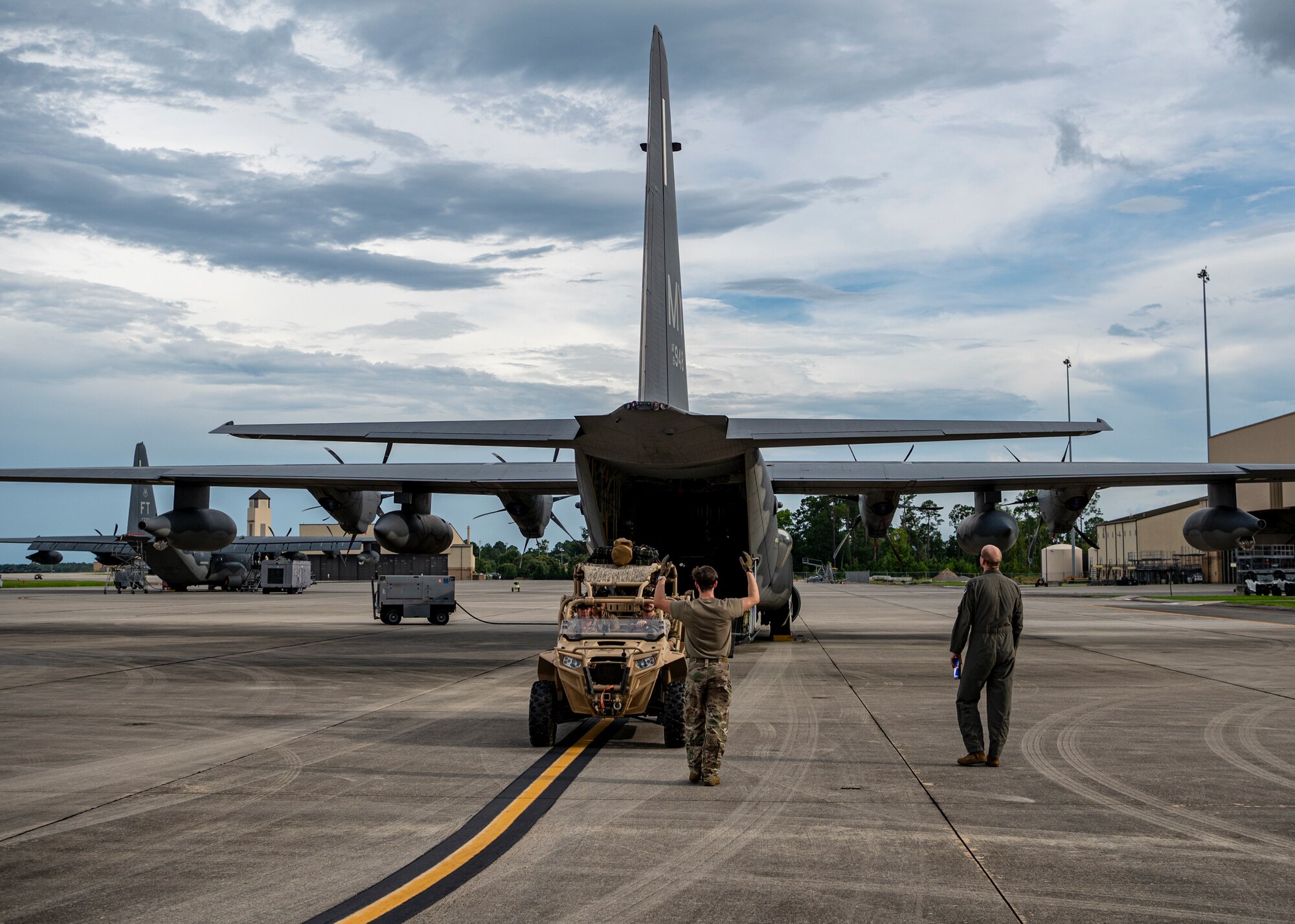 U.S. Air Force Airman 1st Class Eric Peltier, 71st Rescue Squadron loadmaster, marshals Airmen assigned to 38th RQS into an HC-130J Combat King II at Moody Air Force Base, Georgia, July 24, 2024. Rescue Airmen provide the safety net for the U.S. and allied troops in times of natural disaster in all areas of the world. (U.S. Air Force photo by Senior Airman Leonid Soubbotine)