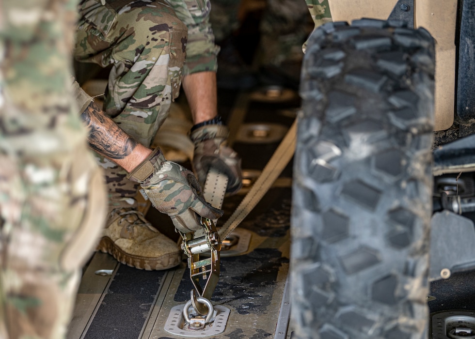 U.S. Air Force Airman 1st Class Tyler Van Antwerp, 71st Rescue Squadron loadmaster, secures a vehicle inside an HC-130J Combat King II at Moody Air Force Base, Georgia, July 24, 2024. Rescue Airmen practice quick loading and unloading of the pararescue off-road vehicles to be able to rapidly deploy in a real-world scenario. (U.S. Air Force photo by Senior Airman Leonid Soubbotine)