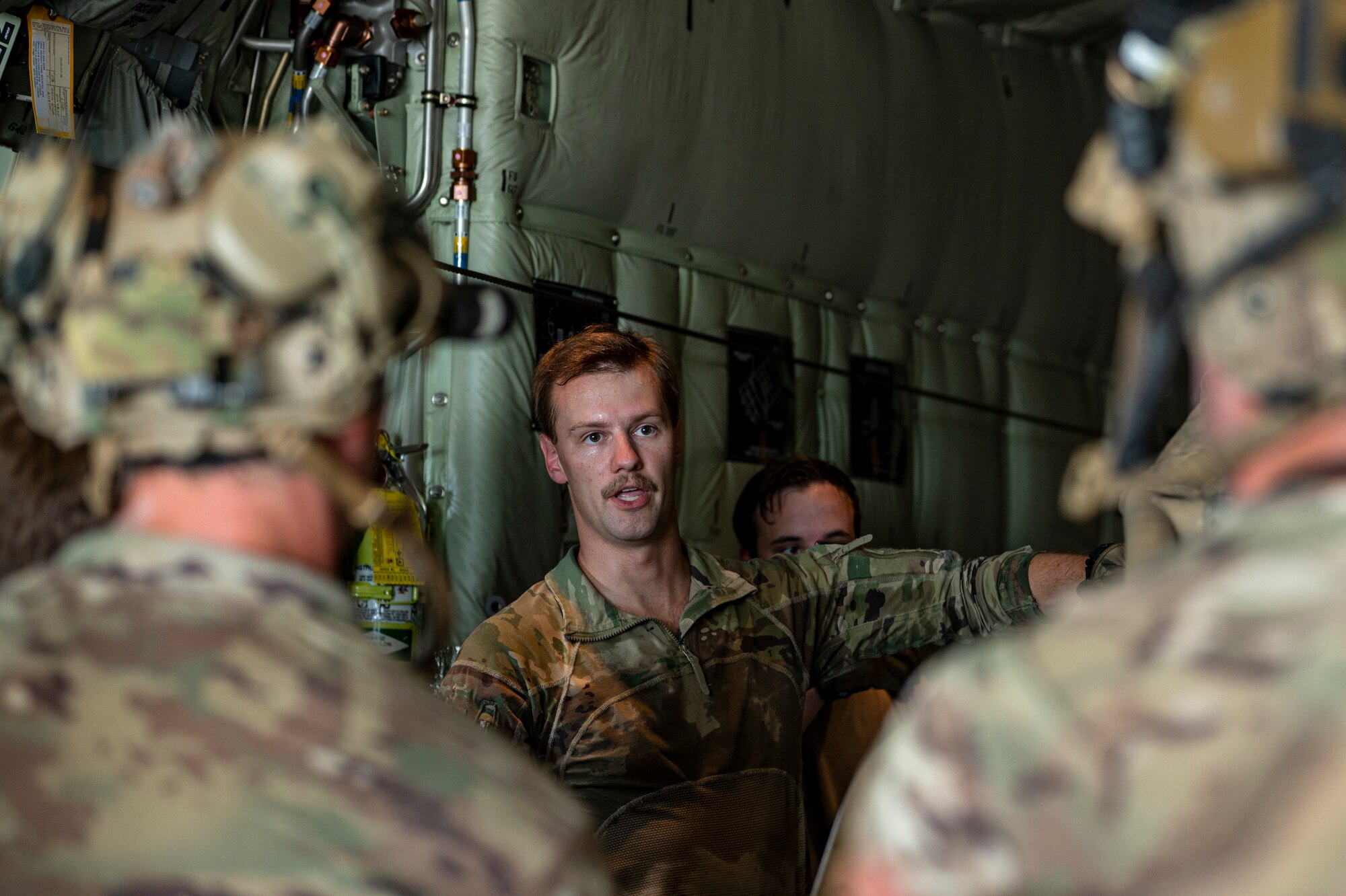 U.S. Air Force Airman 1st Class Tyler Van Antwerp, 71st Rescue Squadron loadmaster, gives instructions to Airmen assigned to 38th RQS at Moody Air Force Base, Georgia, July 24, 2024. Loadmasters and pararescuemen work hand-in-hand during combat search and rescue operations to render aid in the toughest of situations. (U.S. Air Force photo by Senior Airman Leonid Soubbotine)