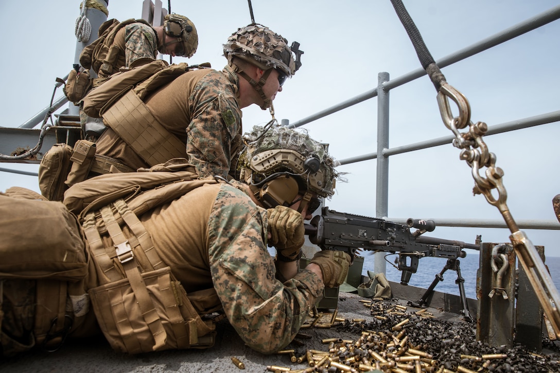 U.S. Marines assigned to Alpha Company, Battalion Landing Team 1/5, 15th Marine Expeditionary Unit, fire an M240B machine gun at floating targets during a live-fire gunnery range aboard the amphibious dock landing ship USS Harpers Ferry (LSD 49) in the South China Sea July 23, 2024. Harpers Ferry and embarked elements of the 15th MEU are conducting routine operations in the U.S. 7th Fleet area of operations. 7th Fleet is the U.S. Navy’s largest forward-deployed numbered fleet, and routinely interacts and operates with allies and partners in preserving a free and open Indo-Pacific region. (U.S. Marine Corps photo by Lance Cpl. Peyton Kahle)