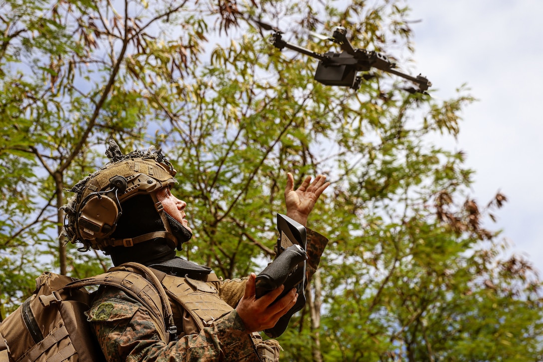 U.S. Marine Corps Lance Cpl. Reece Masset, a rifleman assigned to Charlie Company, Battalion Landing Team 1/5, 15th Marine Expeditionary Unit, launches a small unmanned aerial system to conduct reconnaissance of a simulated enemy compound during force-on-force training Marine Corps Training Area Bellows, Waimanalo, Hawaii, July 22, 2024. Charlie Co., BLT 1/5, partnered with Charlie Co., 3d Littoral Combat Team, 3d Marine Littoral Regiment, to conduct platoon level force-on-force training. (U.S. Marine Corps photo by Cpl. Aidan Hekker)