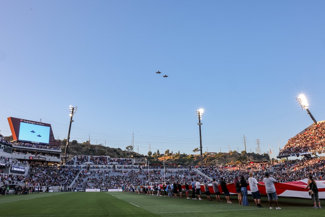 U.S. Marine Corps F-35C Lightning II aircraft assigned to Marine Fighter Attack Squadron (VMFA) 311, Marine Aircraft Group 11, 3rd Marine Aircraft Wing, fly over Snapdragon Stadium, San Diego, during the All Blacks versus Fiji rugby match, July 19, 2024.VMFA-311 supported the flyover to demonstrate U.S. Marine aviation capability, support the shared values of discipline and toughness in the sport of rugby, and connect with more than 33,000 spectators in attendance. U.S. Marine Corps Maj. Alex Black and Maj. Aaron Bucka piloted the F-35C Lightning II aircraft. (U.S. Marine Corps photo by Chief Warrant Officer 2 Trent Randolph)